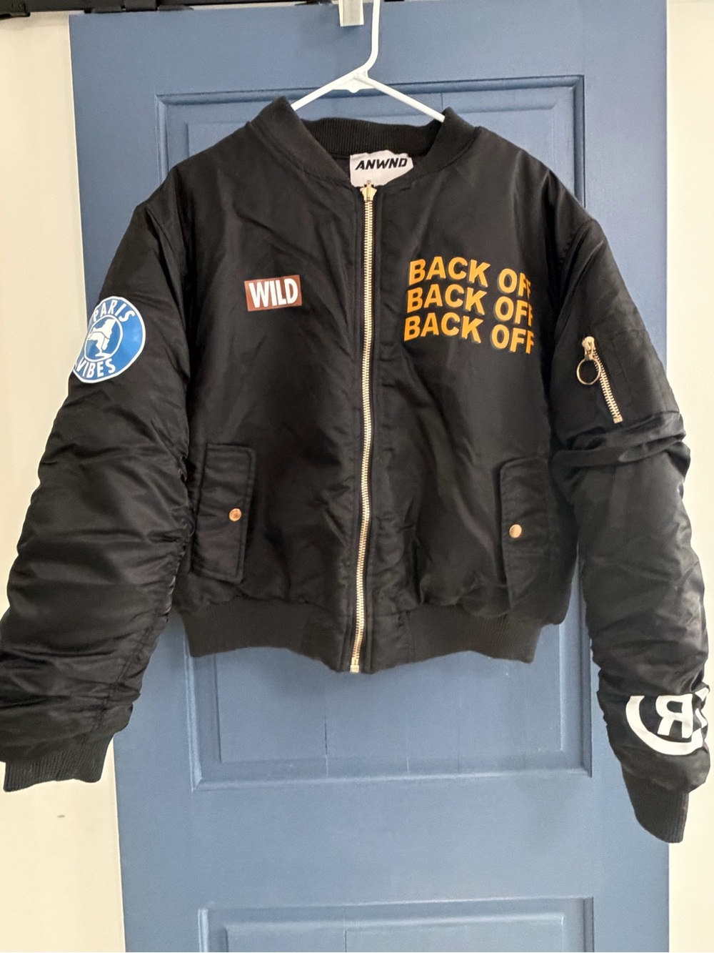 ANWND Black Cropped Bomber Jacket with Bold Yellow 'BACK OFF' Graphic
